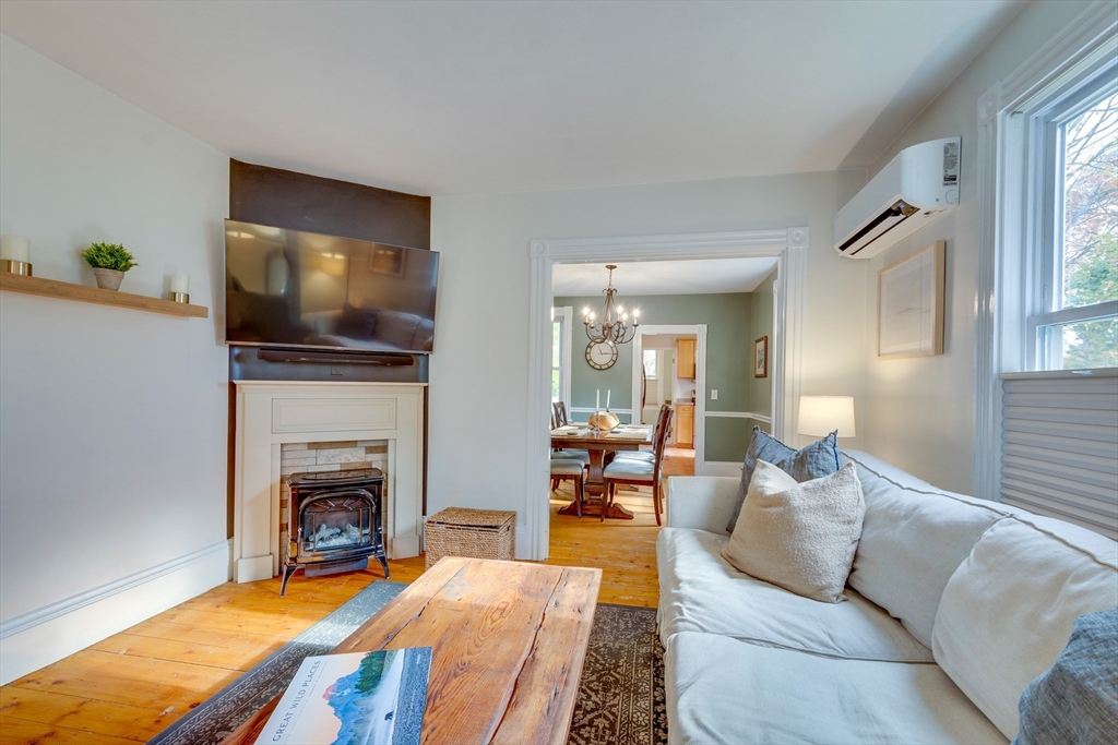 10 Eaton Street Reading, MA 01867 - Photo 5 of 15 a living room with furniture and a fireplace
