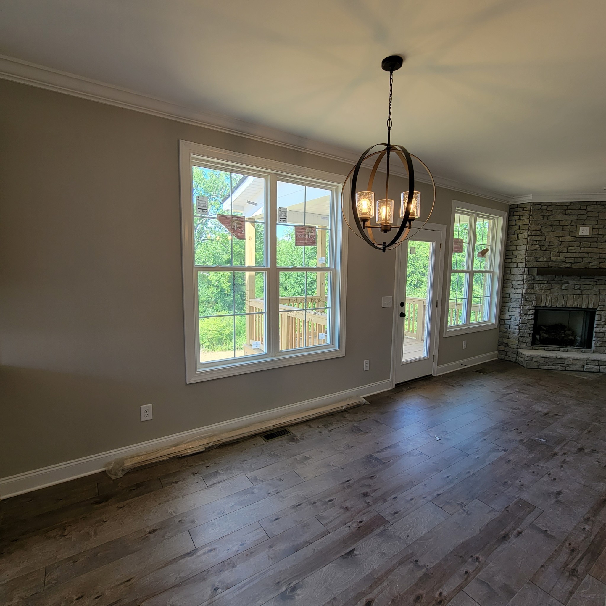 815 Ridgestone Place Lebanon, TN 37087 - Photo 6 of 16 an empty room with wooden floor windows and a fireplace