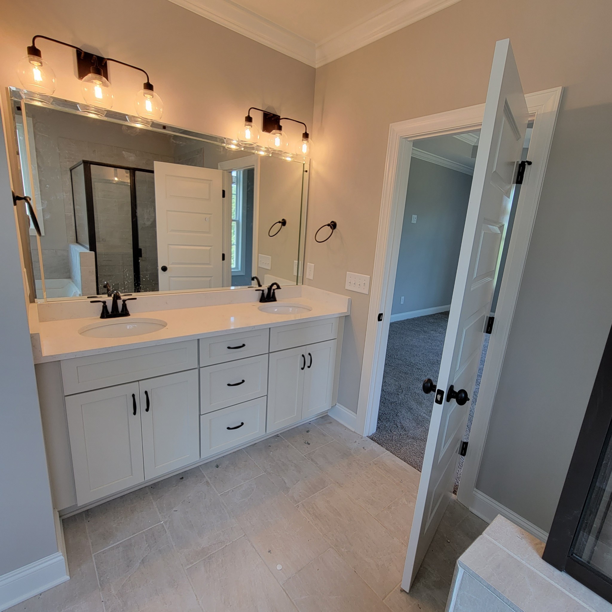815 Ridgestone Place Lebanon, TN 37087 - Photo 8 of 16 a spacious bathroom with a double vanity sink a mirror a vanity and a shower
