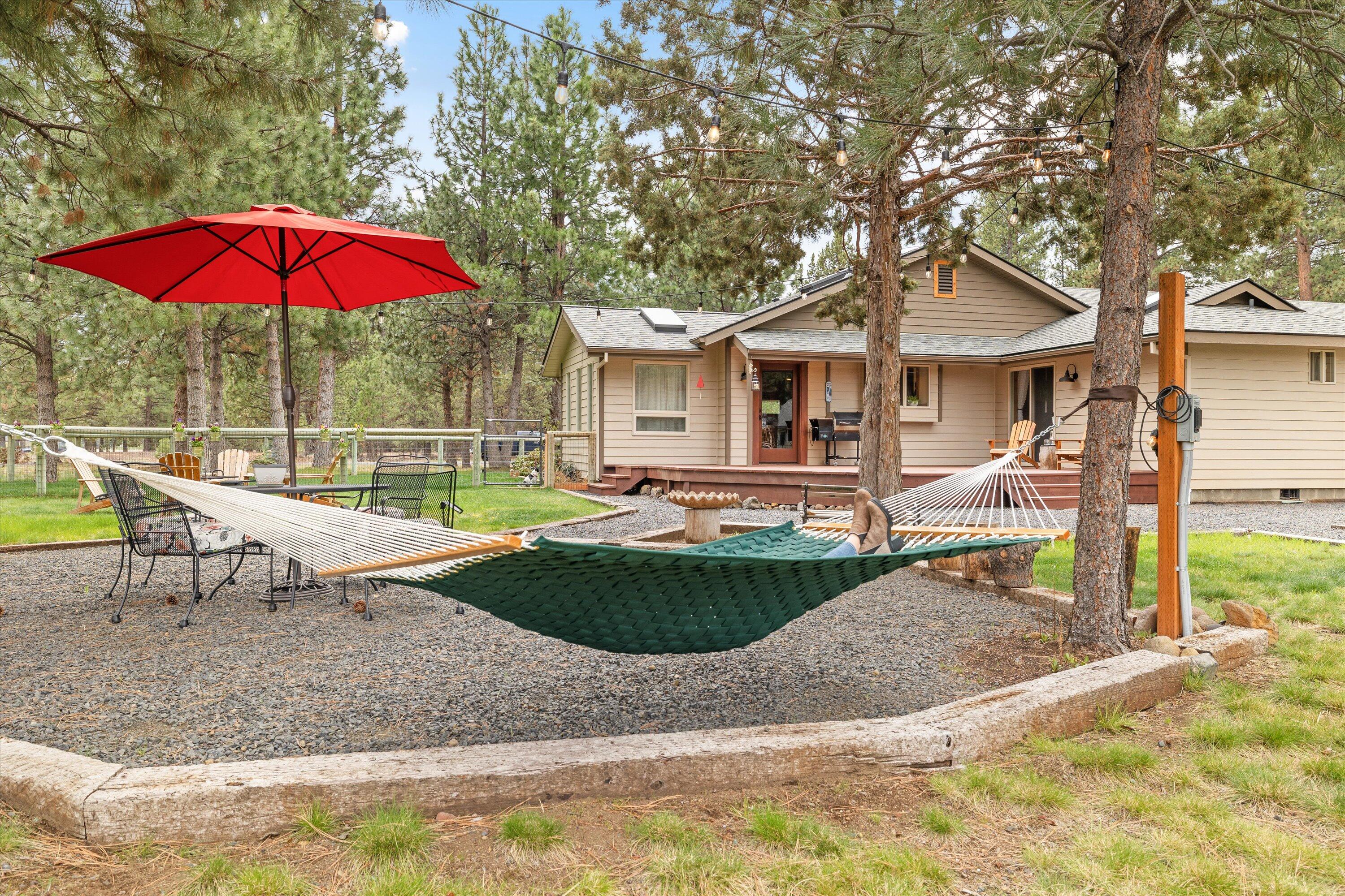 15868 Lundy Road Sisters, OR 97759 - Photo 29 of 53 a view of a house with backyard and porch