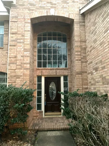 a front view of a house with plants and garden