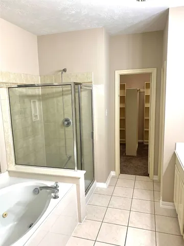 a bathroom with a bathtub and shower