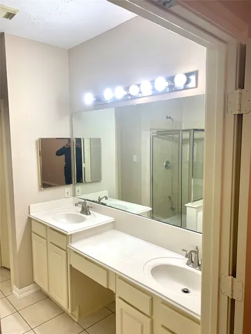 a bathroom with a sink double vanity and a mirror