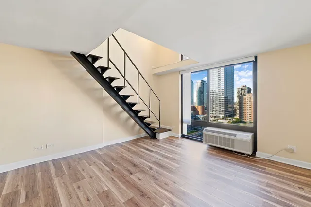 a view of an entryway with wooden floor