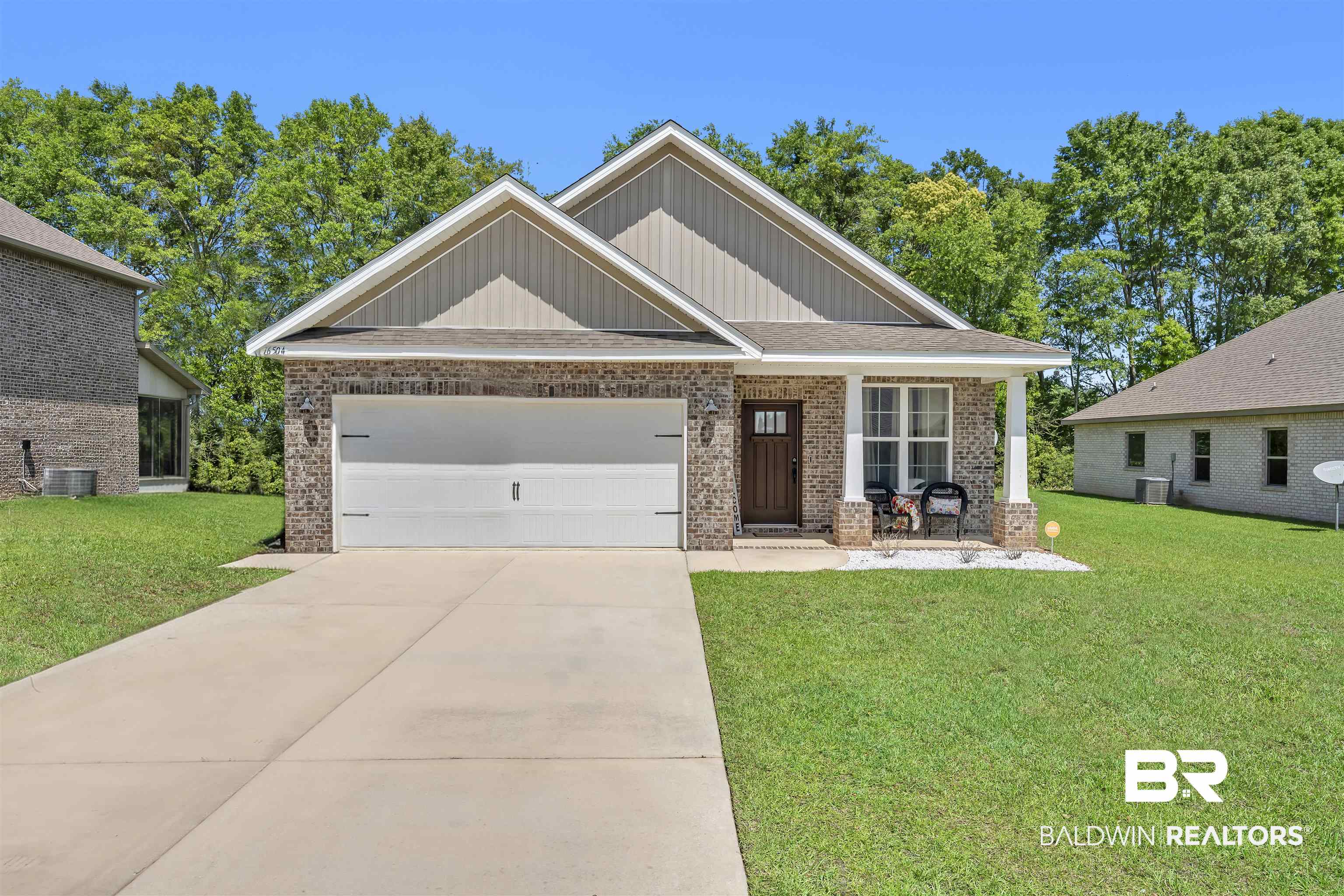 16504 Prado Loop Loxley, AL 36551 - Photo 1 of 45 Craftsman-style home featuring a front lawn, brick siding, concrete driveway, and board and batten siding