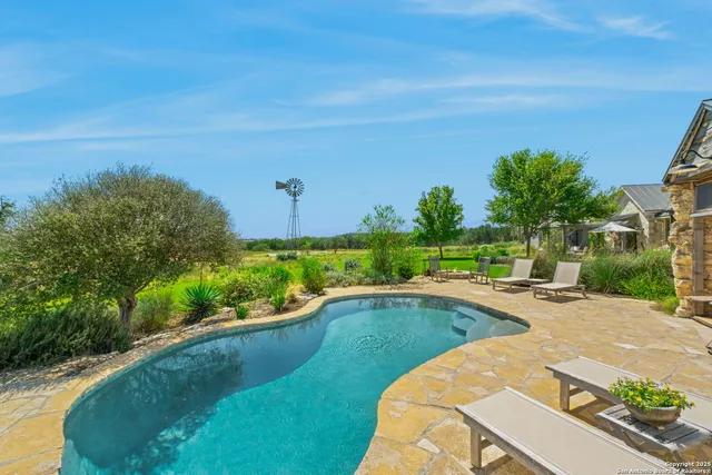 a view of a swimming pool with a yard