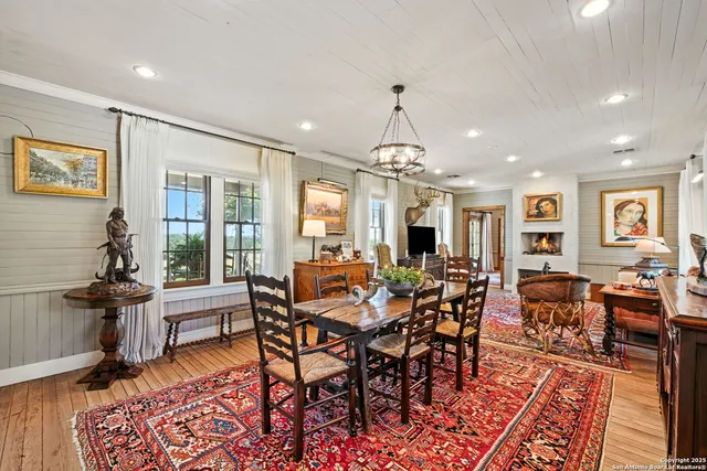 a kitchen that has a lot of cabinets in it and wooden floors