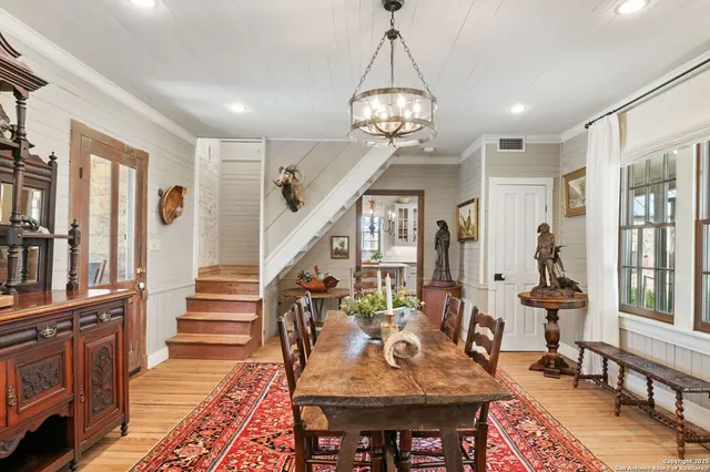 a view of a brick house with plants and large windows
