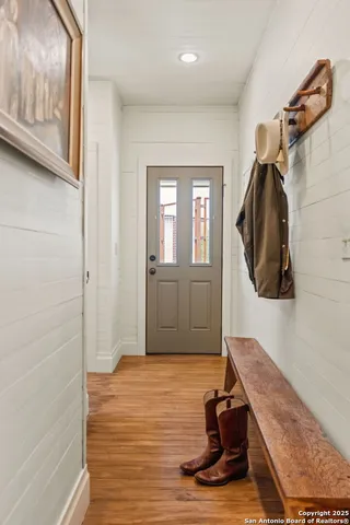 an aerial view of a house with a yard and lake