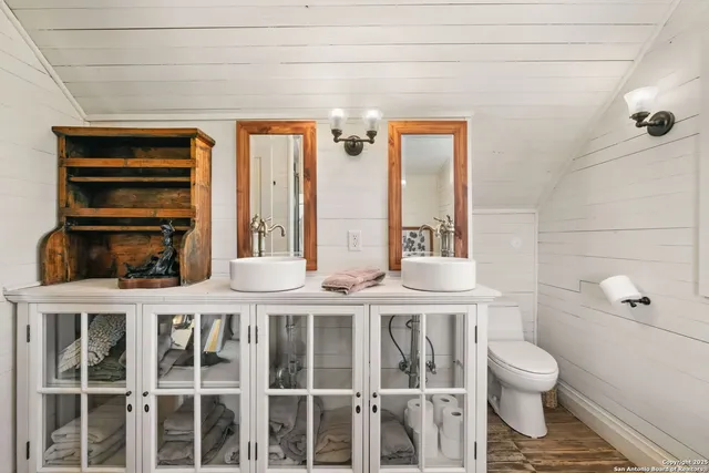 an aerial view of a house with a garden and large trees