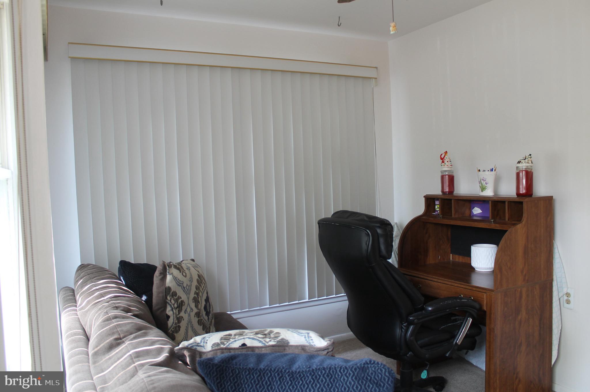 22 Cranberry Road Manahawkin, NJ 08050 - Photo 3 of 37 a living room with furniture and a chair