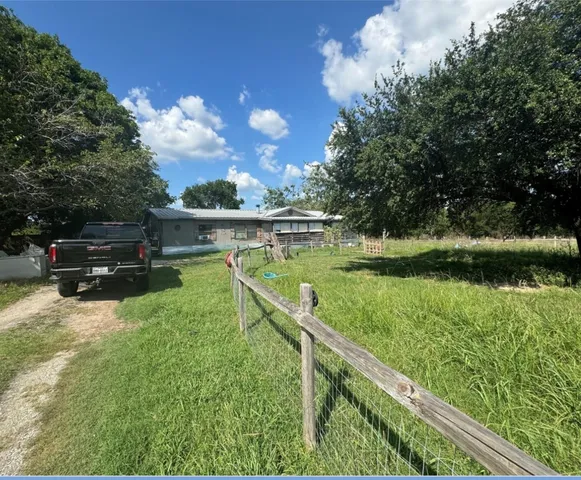 a view of a lake with a house in the background
