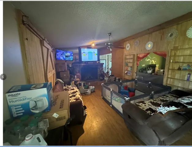 a living room with furniture and a floor to ceiling window