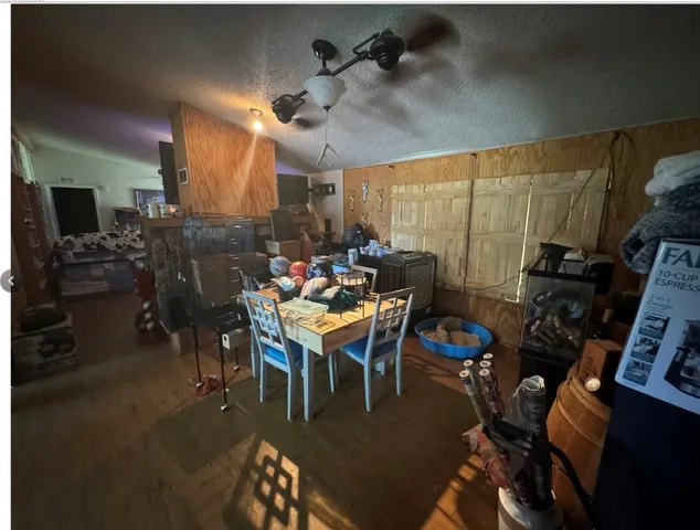 a dining room with furniture window and wooden floor