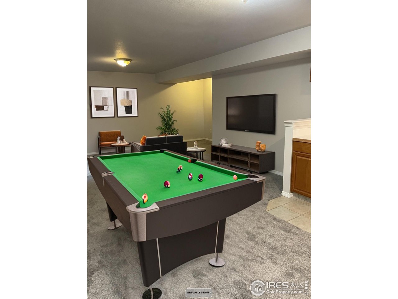 613 Rider Ridge Drive Longmont, CO 80504 - Photo 31 of 34 basement rec room staged