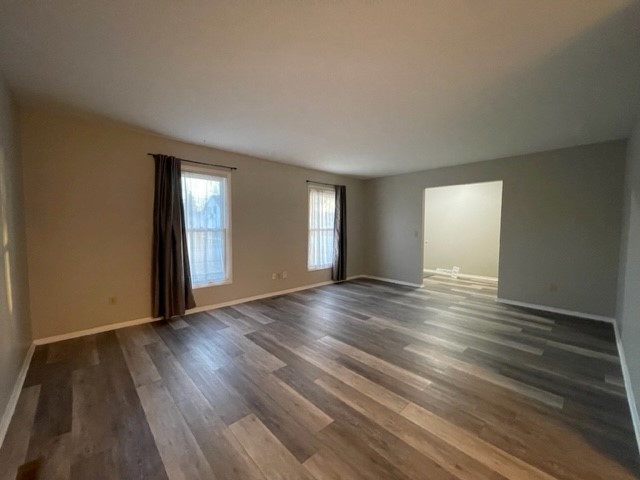 10 Ingleshire Road Montgomery, IL 60538 - Photo 6 of 26 an empty room with wooden floor and windows