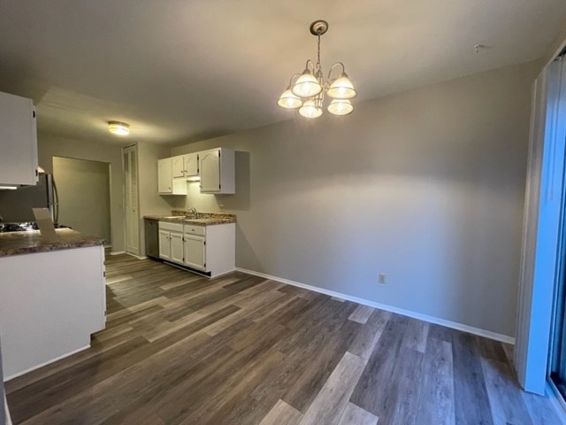 10 Ingleshire Road Montgomery, IL 60538 - Photo 7 of 26 a view of a kitchen with a sink dishwasher a stove top oven with wooden floor