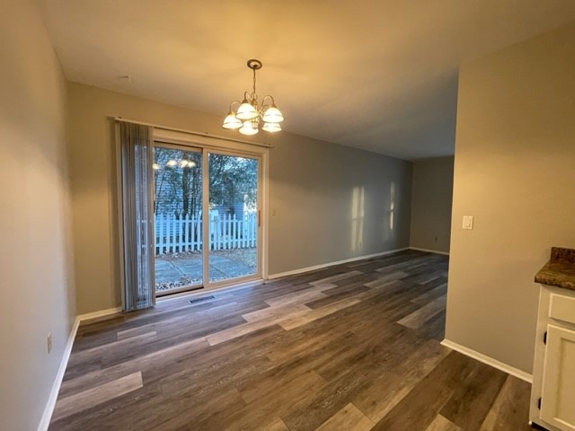 10 Ingleshire Road Montgomery, IL 60538 - Photo 8 of 26 a view of a livingroom with wooden floor and chandelier