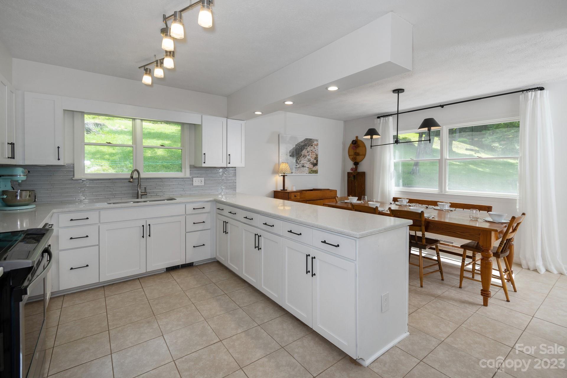 298 Camp Rock Road, Unit 14 Boone, NC 28607 - Photo 14 of 45 a kitchen with cabinets appliances and a large window