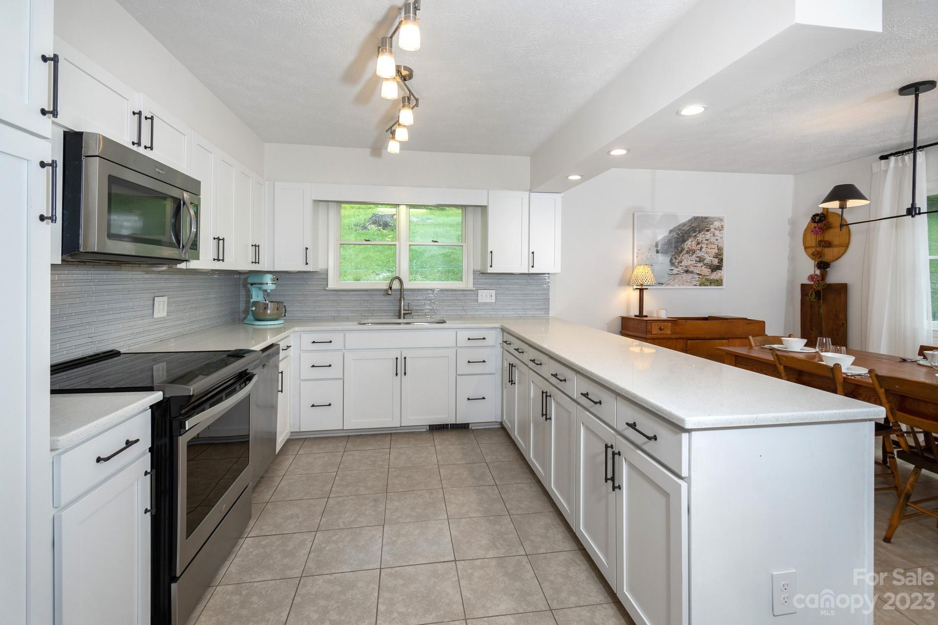 298 Camp Rock Road, Unit 14 Boone, NC 28607 - Photo 16 of 45 a kitchen with stainless steel appliances a sink stove and cabinets