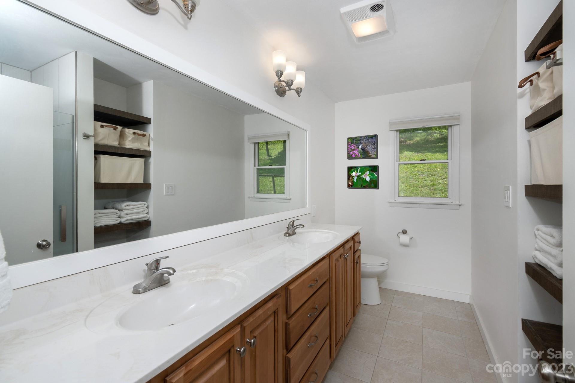 298 Camp Rock Road, Unit 14 Boone, NC 28607 - Photo 32 of 45 a bathroom with a sink double vanity and a mirror