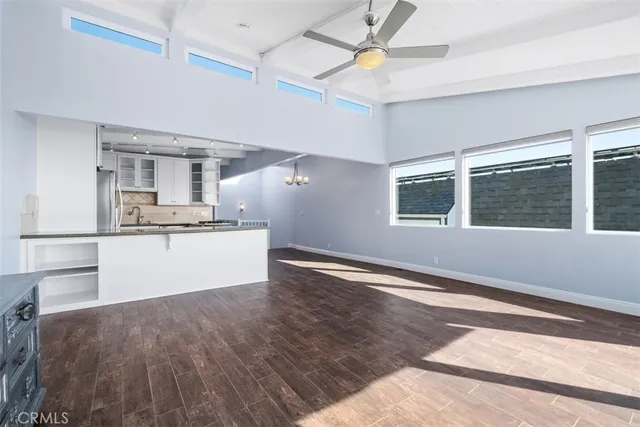 a view interior of kitchen and empty room with wooden floor
