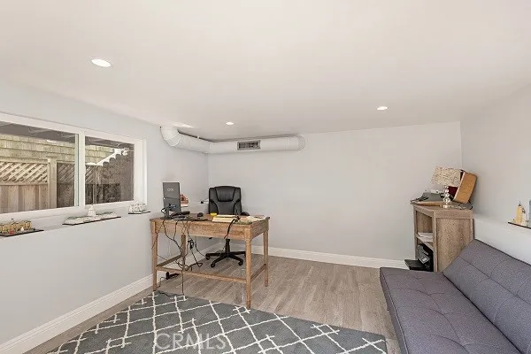 a view of a workspace with furniture and a window