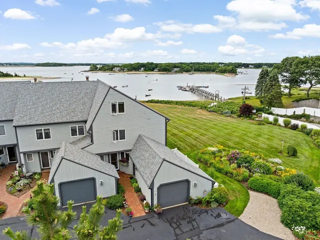 an aerial view of a house with a garden and lake view