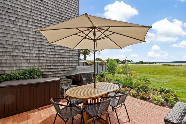 a backyard view with a seating space