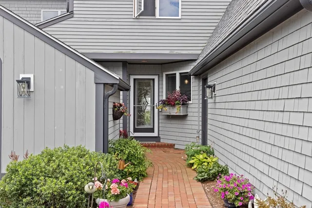 a view of a porch with wooden stairs and a potted plant
