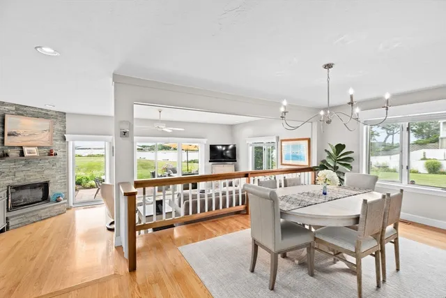 a dining room with furniture window and wooden floor