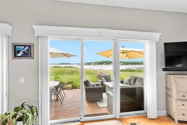 a living room with large windows and a flat screen tv