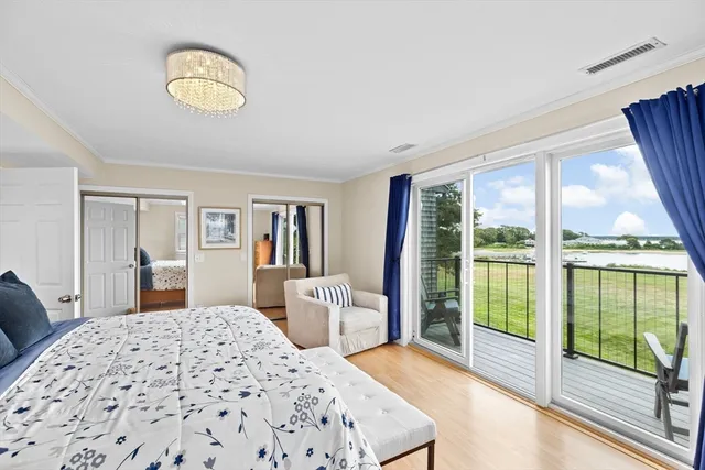 a bedroom with a bed and a large window with outer view