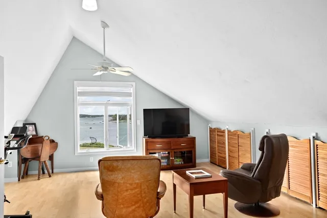 a living room with furniture a flat screen tv and a window