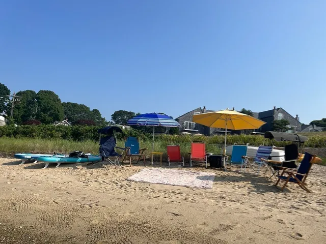 a patio with a table and chairs under an umbrella