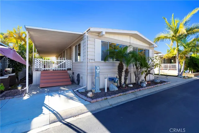 a view of a house with a chairs in patio