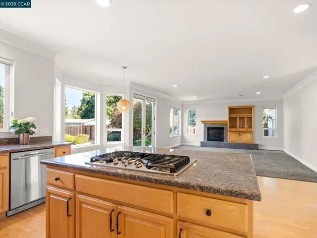 a kitchen with sink stove and large window