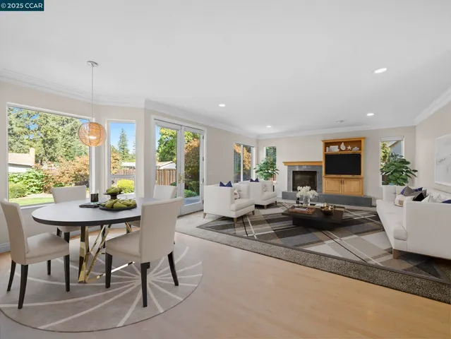 a living room with furniture large window and flat screen tv