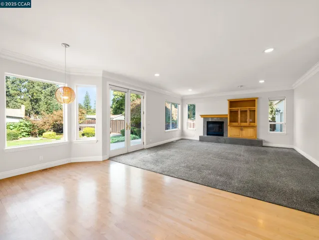 a view of empty room with wooden floor and outdoor view