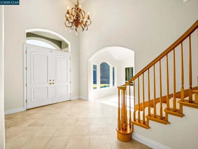 a view of entryway with chandelier and front door