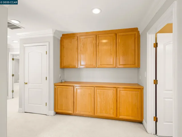 a view of a room with wooden floor and cabinet