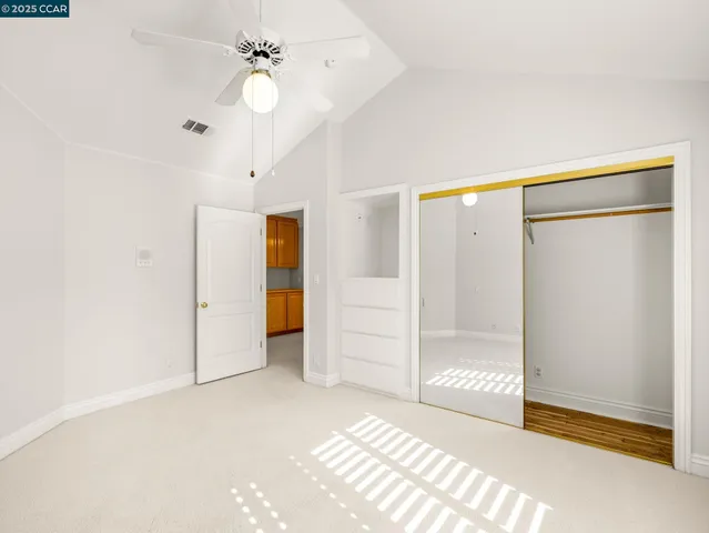 a view of a room with cabinet and a ceiling fan
