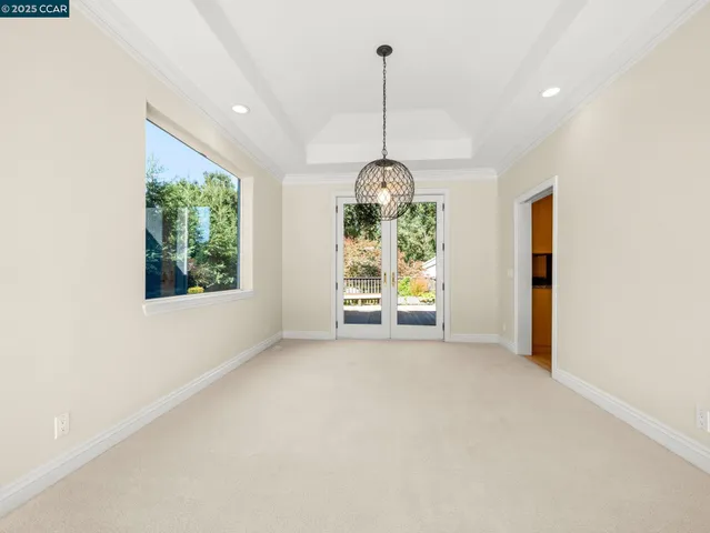 an empty room with windows and outdoor view