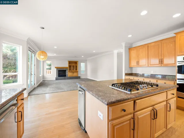 a kitchen with granite countertop a sink stove and cabinets