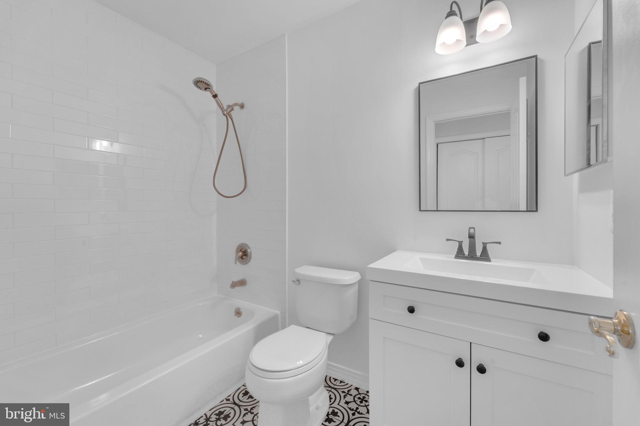 801 Freeport Way Williamstown, NJ 08094 - Photo 24 of 29 a bathroom with a toilet sink vanity tub and mirror