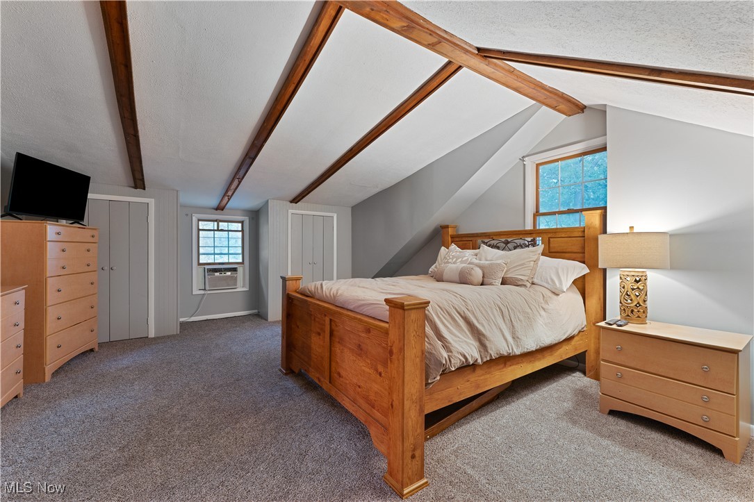 6370 Fairview Road Youngstown, OH 44515 - Photo 27 of 38 Carpeted bedroom featuring multiple closets, a textured ceiling, and cooling unit