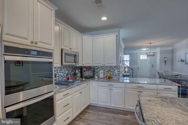 a kitchen with sink cabinets and microwave