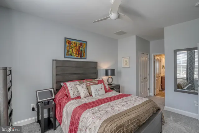 a bedroom with a bed and large windows