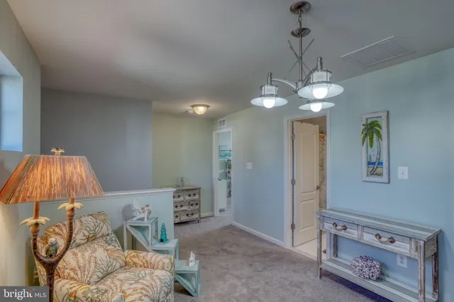 a view of a livingroom with furniture and chandelier