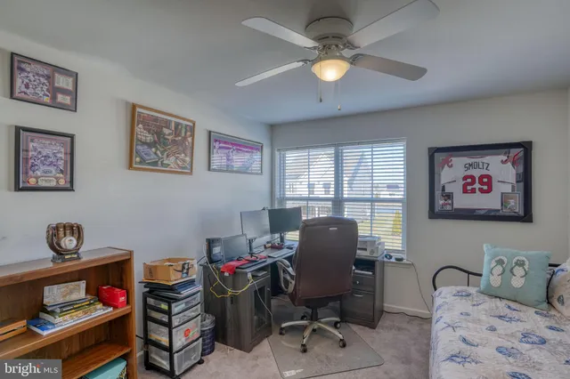 a view of a workspace with furniture and a window
